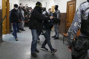 Dalerdzhon Mirzoyev, a suspect in the Crocus City Hall shooting on Friday is escorted by an FSB officer in the Basmanny District Court in Moscow, early on March 25, 2024. (AP Photo)