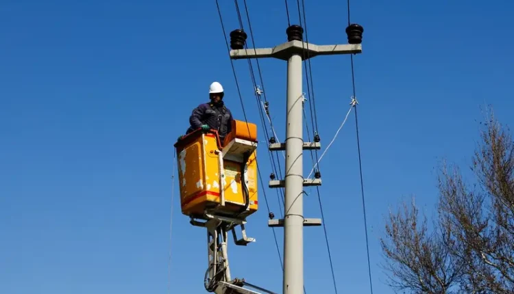 A technician works on an electrical line in the aftermath of a deadly earthquake in Kahramanmaras, Turkey, February 8, 2023.