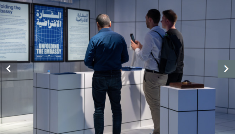 As visitors enter the space, they are teleported to the year 2040. A SpaceX satellite orbiting the globe is the new reality, complete with a reception area, books, and brochures. (AN photo by Huda Bashatah)