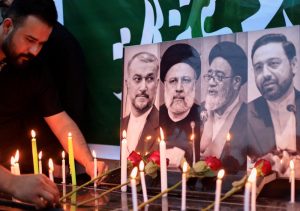 A man lights a candle to offer condolences outside the Iranian embassy, in Baghdad. (Reuters)