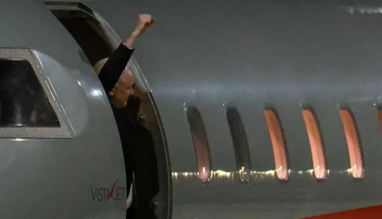 Julian Assange pumped his fist into the air when he landed