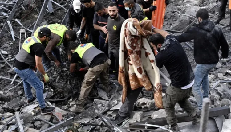 In Almat, Jbeil district, Lebanon, on November 10, 2024, rescuers and civilians look at the rubble at a spot that was hit by an Israeli air strike [Wael Hamzeh/EPA]