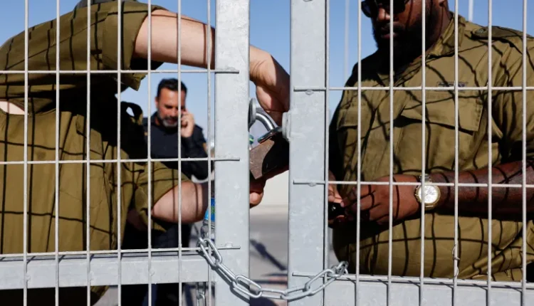 At Sde Teiman, an Israeli prison camp near Bir as-Sab' (Beersheba), soldiers lock a gate from the inside.