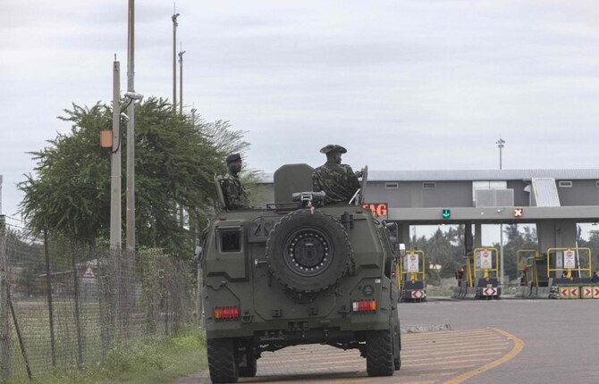 Above, riot police guard a toll gate on the N1 highway that connects Mozambique with South Africa