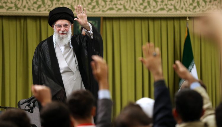 Leader of the Islamic Revolution Ayatollah Seyyed Ali Khamenei waves to a group of students during a meeting in Tehran