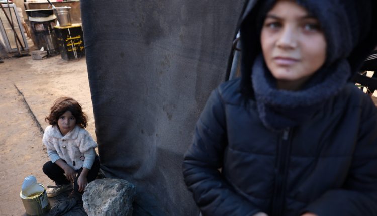 Displaced Palestinian children are seen at a food distribution center in Deir el-Balah in the central Gaza