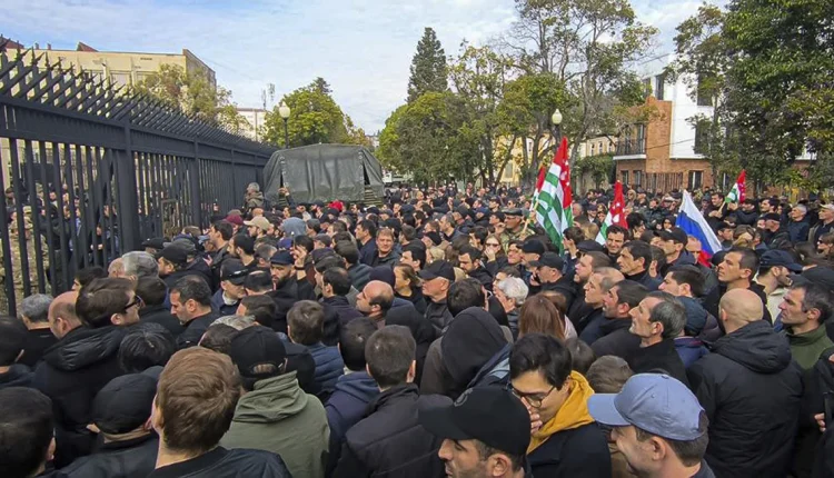 Demonstrators assemble outside the parliament building in the Abkhazia separatist province of Georgia.