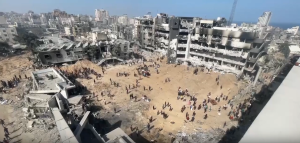 People walking around destruction at Shifa Hospital comple