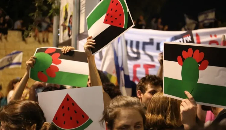Jerusalem, Israel, July 23, 2023: Watermelon or "freedom" signs are being waved by Palestinian flag-colored protesters. National Security Minister Itamar Ben Gvir has banned Palestinian flags, leading demonstrators to hoist these signs.