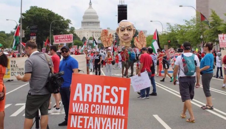 Pro-Palestinian demonstrators hold up banners and an effigy of Israeli prime minister Benjamin Netanyahu as they denounce his visit to the US, at the Capitol in Washington