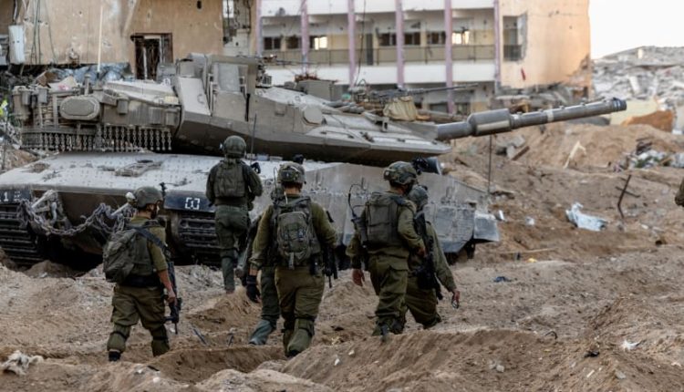 Israeli soldiers make their way towards Israel's border with Gaza, amid the ongoing ground invasion against Hamas, in southern Israel