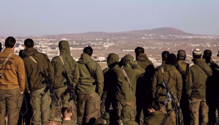 Israeli soldiers look into Syria, after the fall of President Bashar al-Assad, in Ein Zivan in the Israeli-occupied Golan Heights
