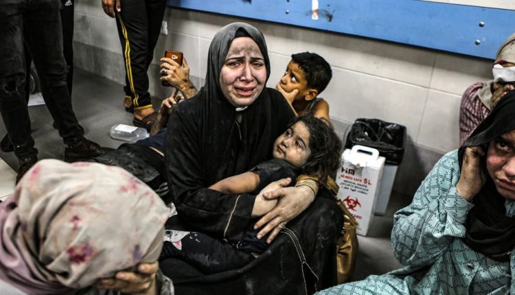 Palestinian women and children wait for treatment at Gaza's Al-Shifa Hospital.