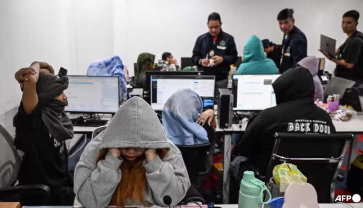 During a raid on January 31, 2025, workers were found at their desks as agents from the Presidential Anti-Organized Crime Commission (PAOCC) and the National Bureau of Investigation (NBI) conducted an operation at an office suspected of being an online scam farm in Manila. (Photo: AFP/Jam Sta Rosa)