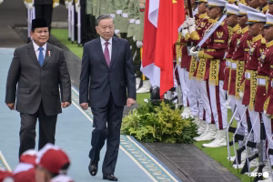 Indonesia's President Prabowo Subianto (left) and Vietnam's Communist Party General Secretary To Lam (centre) inspect the Presidential guard of honour at the Presidential Palace in Jakarta on Mar 10, 2025.