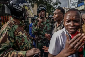 Kenya police interact with demonstrators marching in downtown Nairobi, Kenya [Luis Tato/AFP]