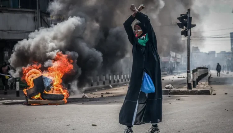 A protester reacts in front of a burning barricade in downtown Nairobi, Kenya, June 25, 2025