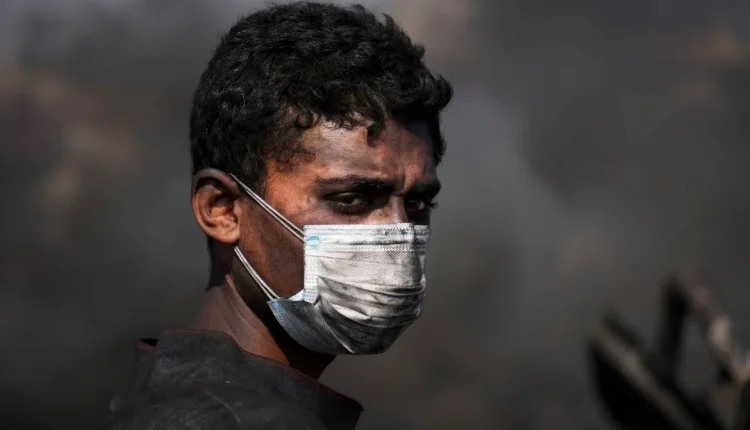 Mohammed Najm working at a makeshift burner used to extract fuel from melted plastic
